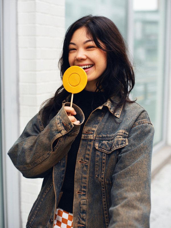 A smiling portrait with a yellow cookie · Cool Analog